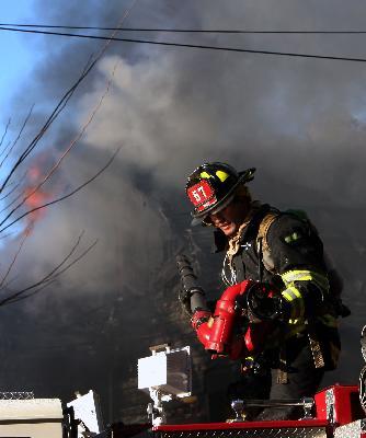 BHFD FF sets up deck gun at Bedford Hills Structure Fire on Route 117. Photo by Frank Becerra. (12/26/08)